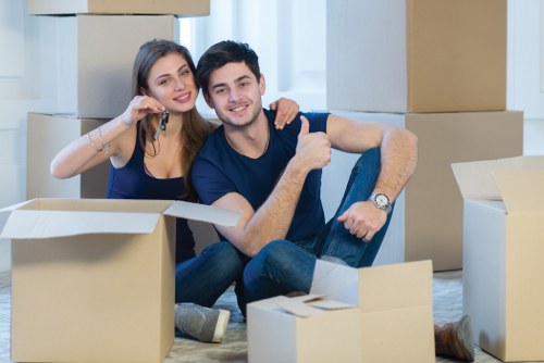 Team handling office furniture and equipment during a business relocation