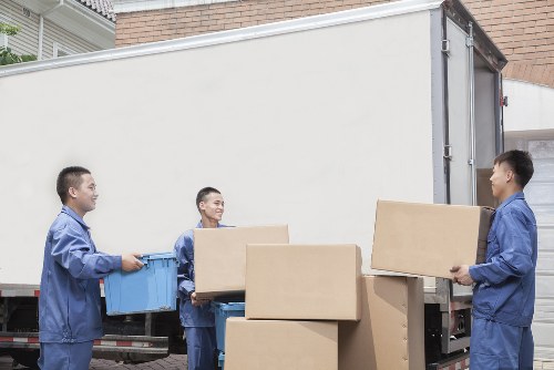 Removal van and moving team in a West Hampstead street