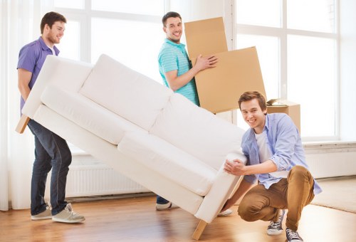 Removal team handling furniture in a West Hampstead flat